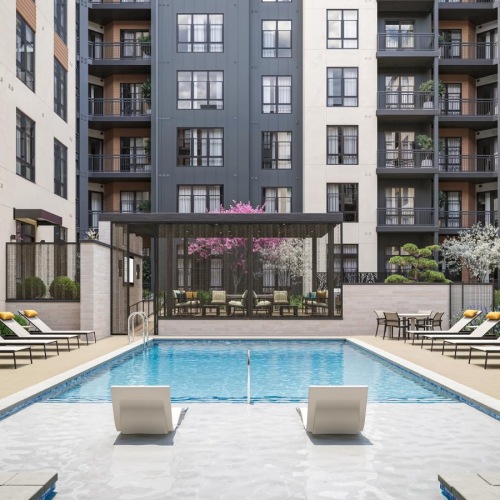 a swimming pool in a courtyard between buildings